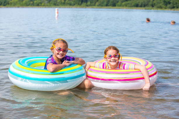 istock Two Girls In Innertube Float Toys At Beach 1020319718