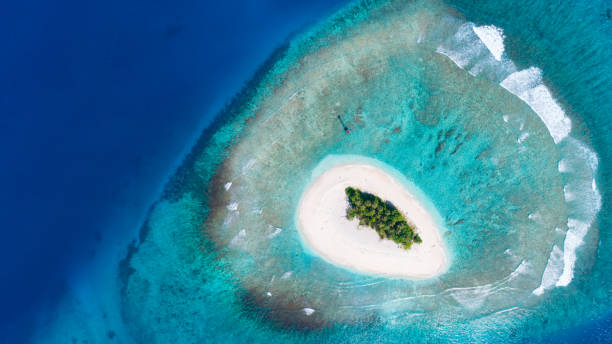 Desert Island 2 Aerial view of a small desert island off the coast of Sumatra, Indonesia desert island stock pictures, royalty-free photos & images