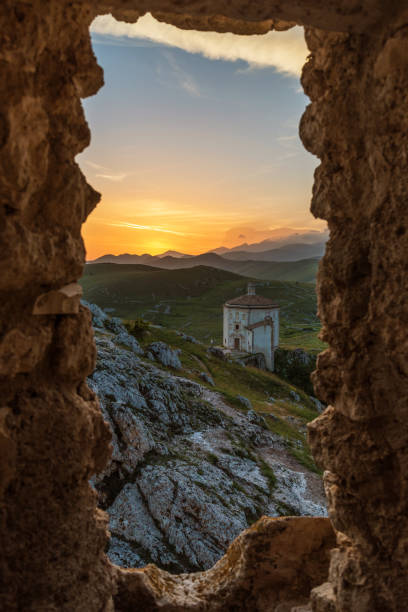 The ruins of an old medieval village with ruins and church, over 1400 meters above sea level on the Apennine mountains in the heart of Abruzzo, at sunset.