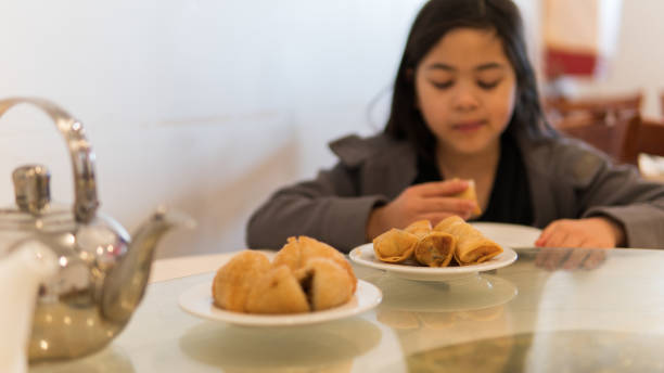Defocused image of a young girl enjoying dim sum for lunch
