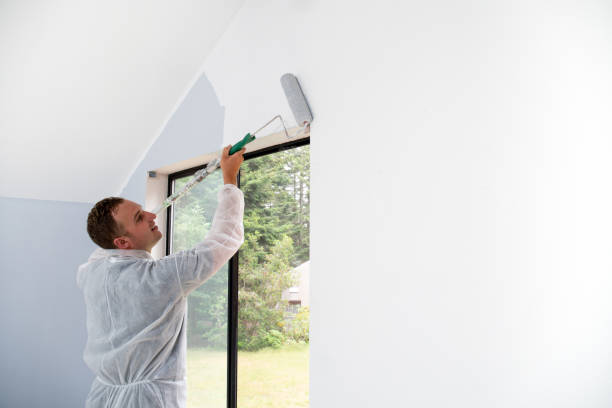 istock Man painting interior of home with roller 1020365418