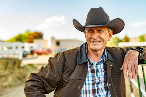 Portrait of a Senior Cowboy on a Horse Ranch Portrait of a senior cowboy on a horse ranch corral photos stock pictures, royalty-free photos & images