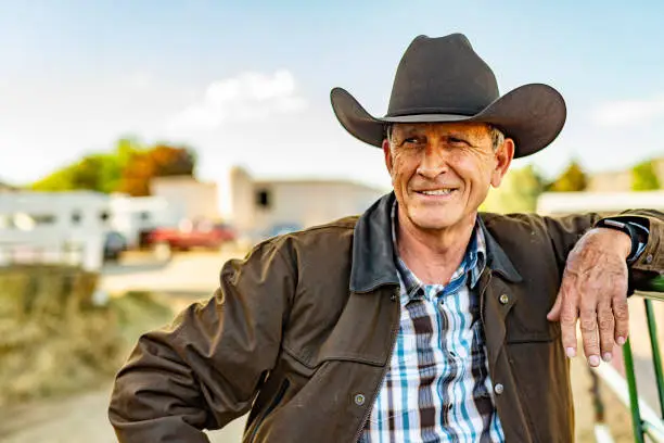Portrait of a senior cowboy on a horse ranch