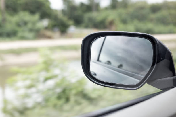 istock Side Mirror a car, reflection of traffic flow in left side rear view mirror 1020380300