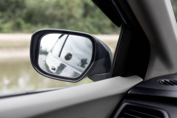 istock Side Mirror a car, reflection of traffic flow in left side rear view mirror 1020380314