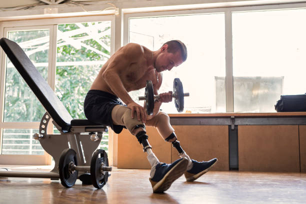 istock Disabled young man working out with dumbbells 1020390822