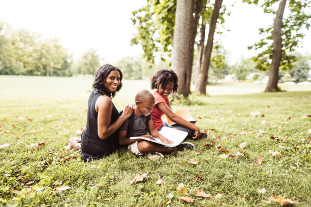 istock family doing the homework in the park 1020396106