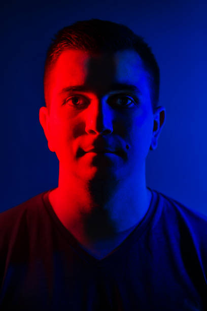 istock young man close head portrait red blue double colors light 1020403408
