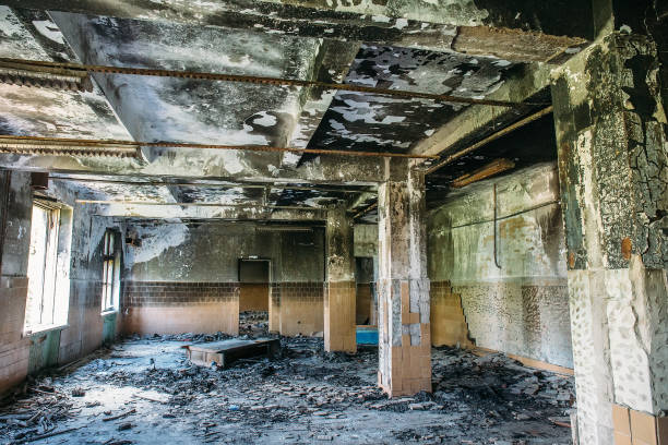 istock Burnt house interior. Burned room with columns, charred walls and ceiling in black soot 1020403738