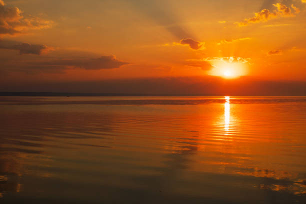istock Dramatic sunset sky with clouds over lake. Composition of nature 1020422074