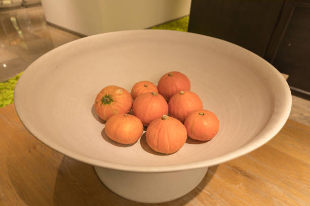 8 pumpkins in a big bowl