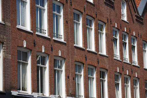 Facade and windows details of canal houses in Amsterdam .