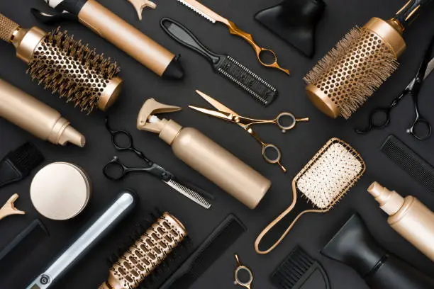 Photo of Full frame of professional hair dresser tools on black background