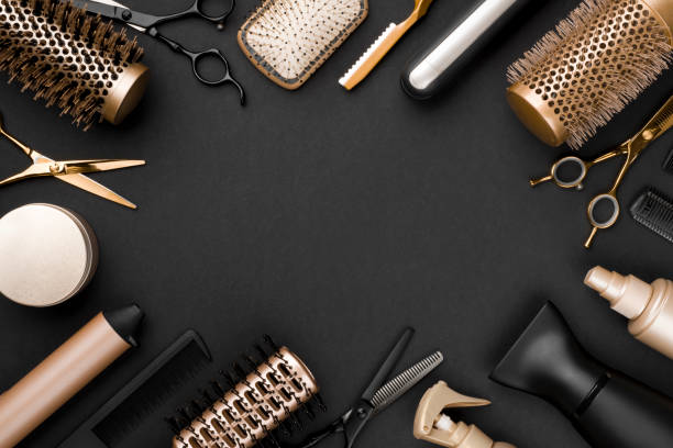Hairdresser tools on black background with copy space in center stock photo
