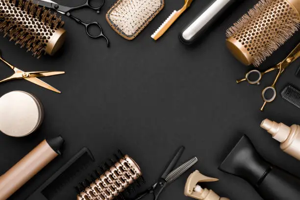 Photo of Hairdresser tools on black background with copy space in center