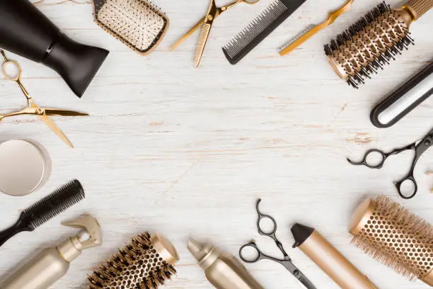 Photo of Various hair dresser tools on wooden background with copy space