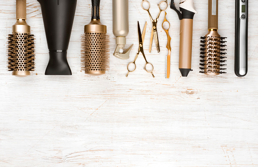 Professional hair dresser tools on wooden background with copy space