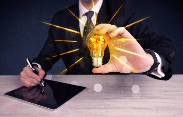 istock business person holding an electric light bulb 1020441916