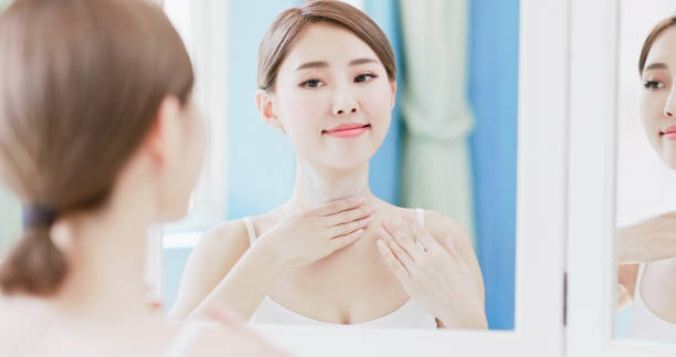 istock woman apply cream with neck 1020462110