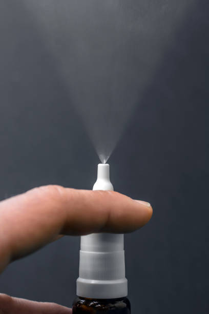 istock Spraying nasal spray in front of black background 1020467748