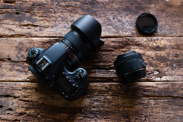 istock photo camera and lenses on a wooden background 1020468482