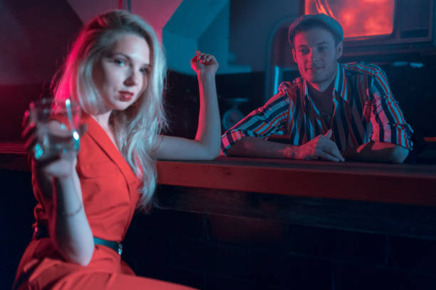 istock Young Woman and Handsome Bartender. Easy Flirting in Bar at Night 1020470964
