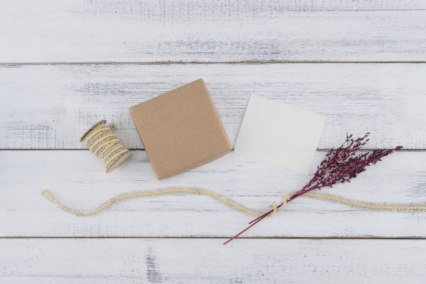 istock Brown gift box, white tiny card, brown rope and violet dried flower 1020471450