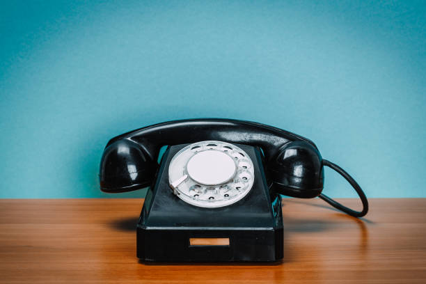 istock Old phone on wooden table 1020474352