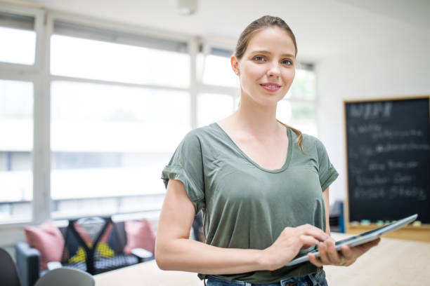 istock Confident businesswoman with digital tablet in office 1020483838