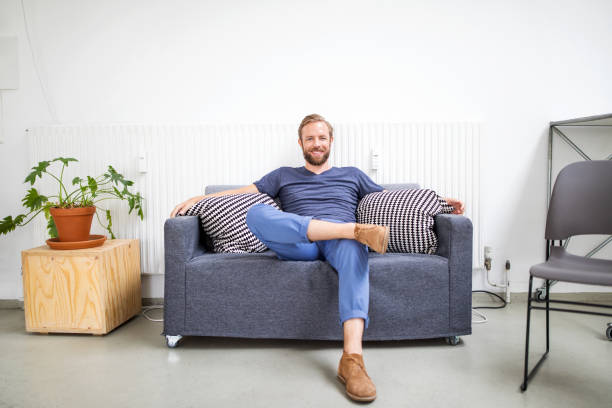 Mid adult businessman relaxing on sofa
