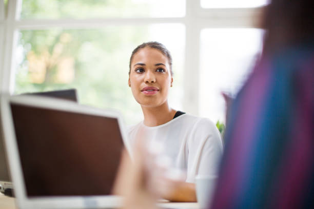 istock Mixed race business woman discussing work with colleague 1020484538