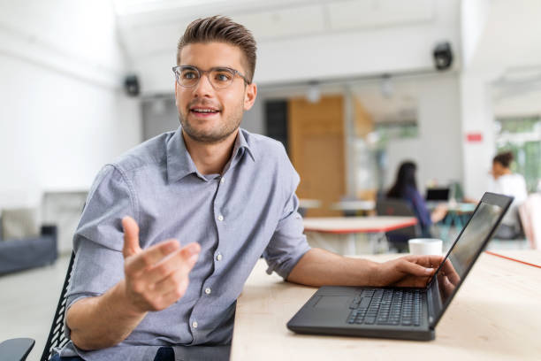 istock Handsome businessman discussing with colleague 1020489336