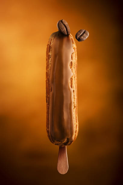 istock Eclair on a stick with coffee toping and coffee bean on top 1020498064