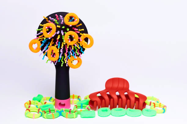 istock Colorful comb with bright multi-colored elastic bands for hair and barrette on a white background. 1020498106
