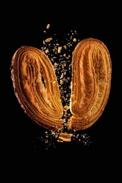 Photo of Palmier cut in half with crumbs