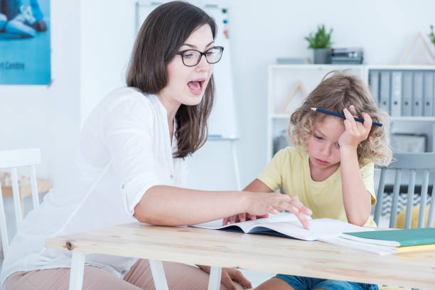 istock Speech therapist teaching a language an autistic child in an office 1020504438