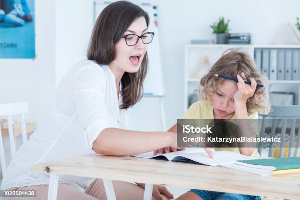 Speech Therapist Teaching A Language An Autistic Child In An Office Stock Photo - Download Image Now
