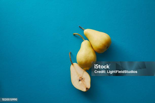 Top View Of Ripe Pears On Blue Surface Stock Photo - Download Image Now - Pear, Directly Above, High Angle View