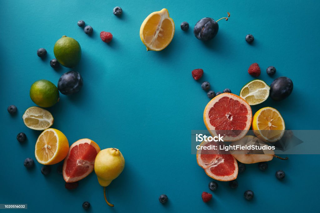 top view of organic ripe fruits and berries on blue surface Antioxidant Stock Photo