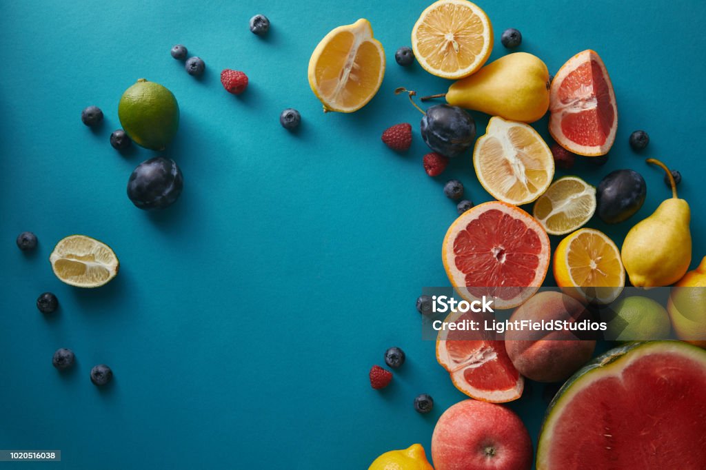 elevated view of appetizing ripe fruits and berries on blue surface Antioxidant Stock Photo