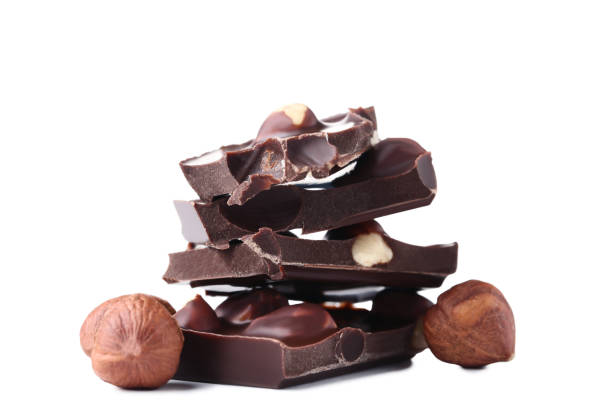 istock Chocolate pieces with hazelnuts isolated on white background 1020516740