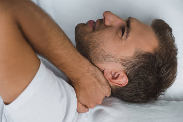 istock man lying in bed and suffering from pain in neck 1020527216