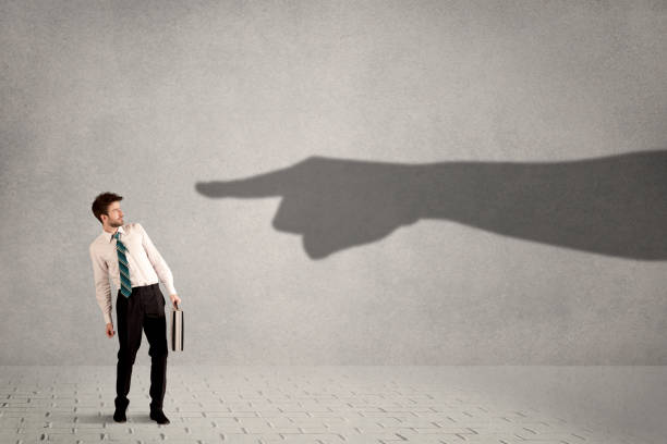 istock Business person looking at huge shadow hand pointing at him concept 1020527712