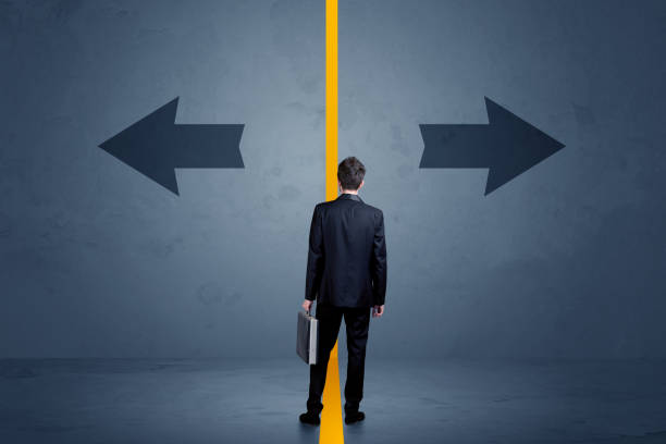 istock Business person choosing between two options separated by a yellow border arrow 1020527970