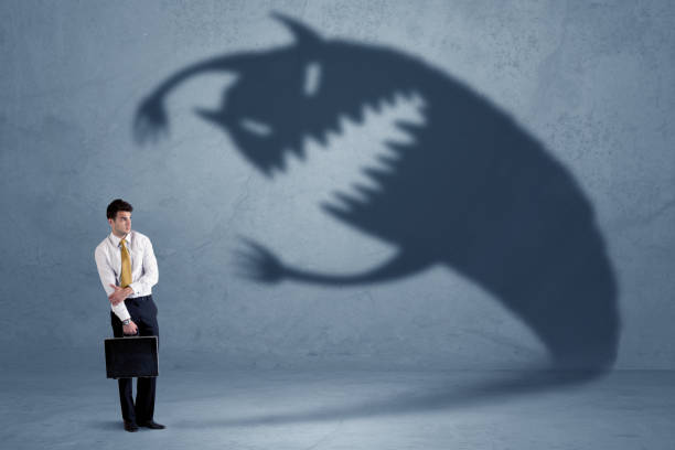 istock Business man afraid of his own shadow monster concept 1020530252