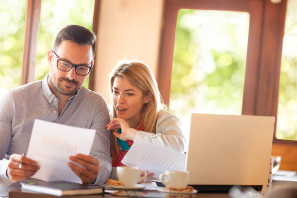 istock couple working together sitting at the cafe during the coffee break 1020532470