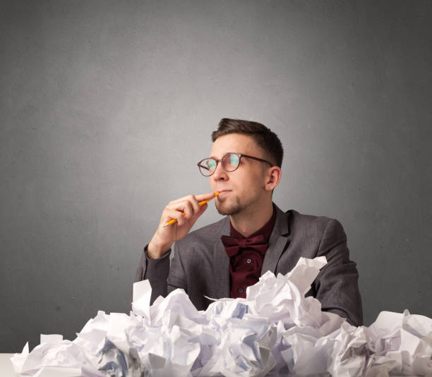 istock Businessman behind crumpled paper 1020532562