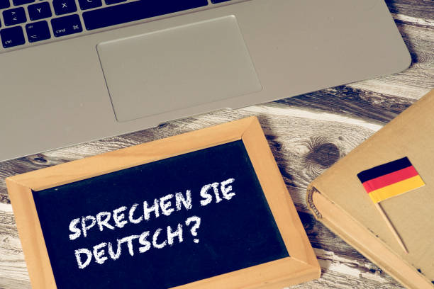 istock A computer, flag of Germany and a chalkboard with the question Speak german 1020532722