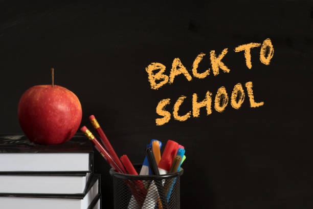 an apple, books and slogan back to school - reading and writing blackboard book elementary school building imagens e fotografias de stock