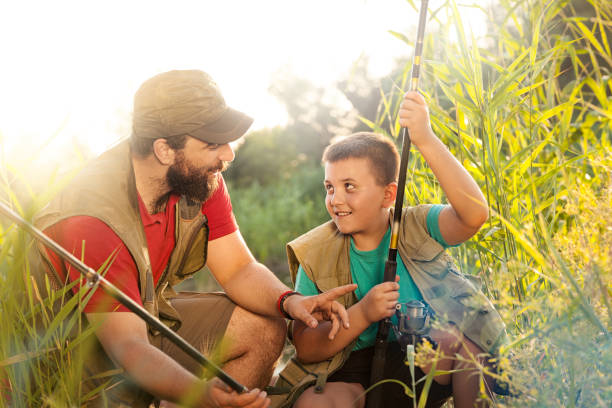 istock Father and son preparing fishing lines 1020538680